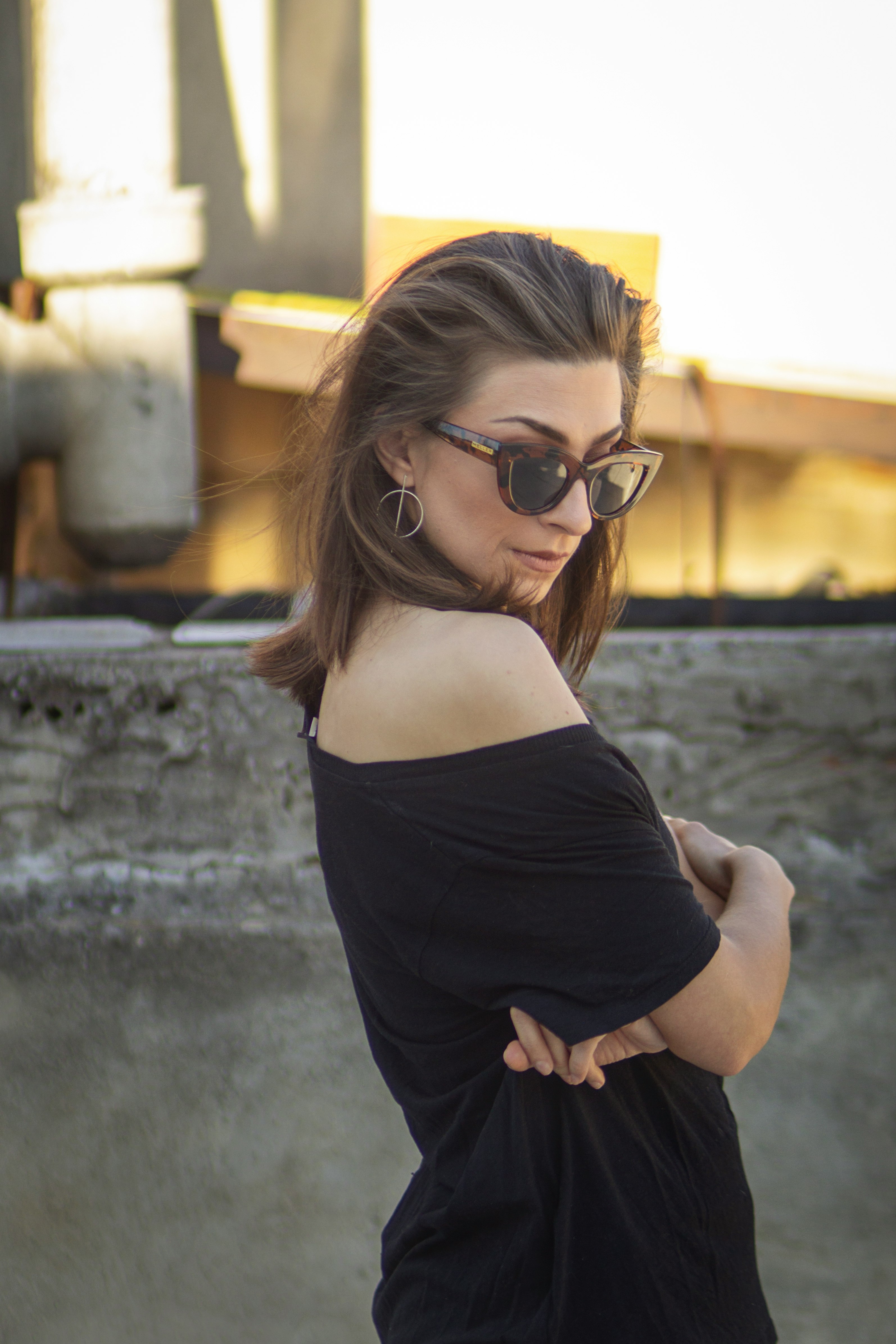 woman in black off shoulder shirt wearing black framed eyeglasses